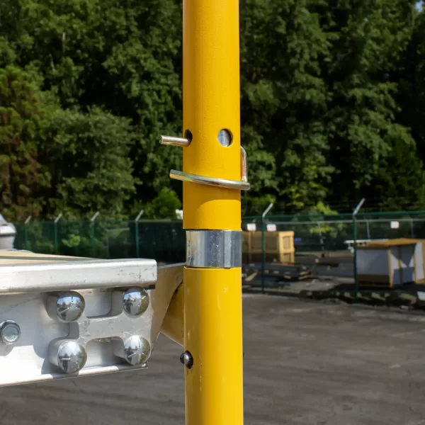 Joint of a scaffolding frame and safety rail connected with a stack pin and pigtail.